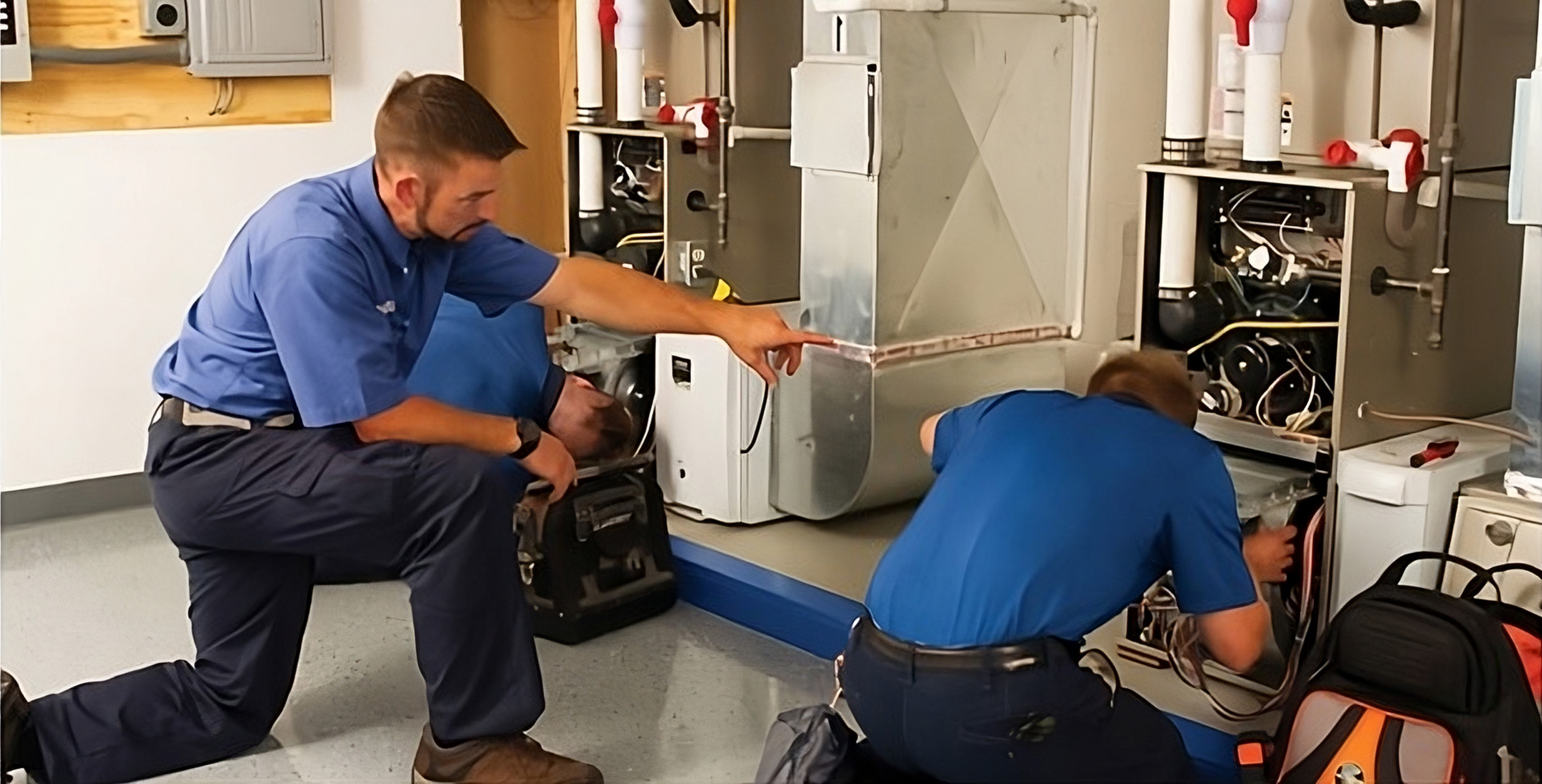 Team of Furnace Installation Technicians working together on a home furnace install.
